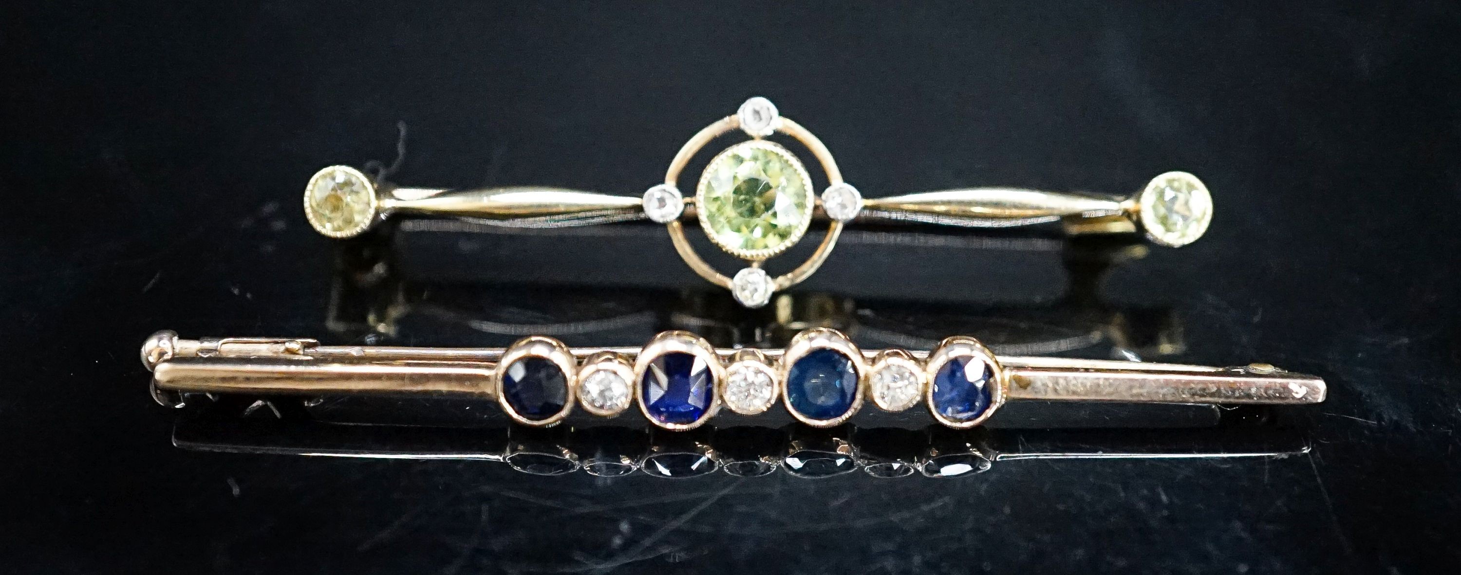 An Edwardian 15ct, peridot and diamond set bar brooch, 49mm, gross weight 4.4 grams and a yellow metal, sapphire and diamond set seven stone bar brooch, gross 3 grams